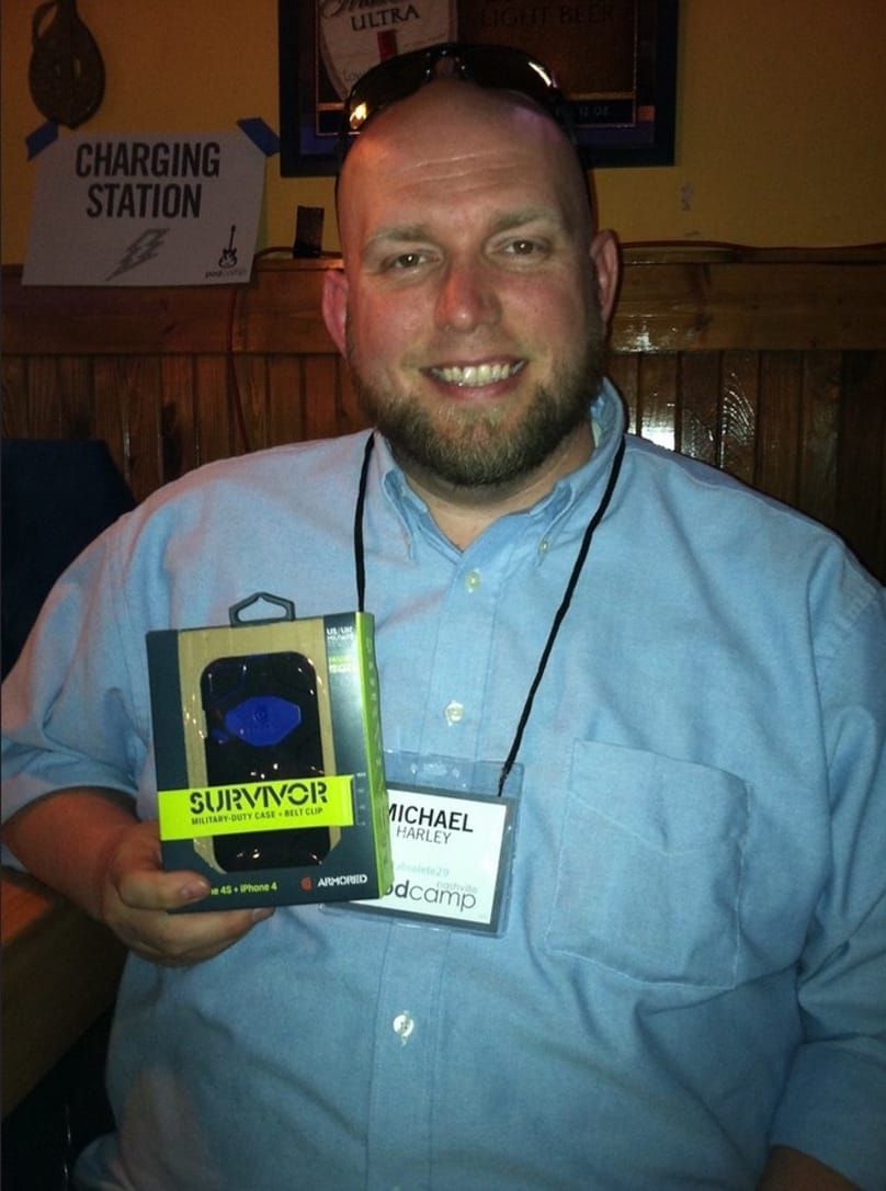 Mike holding a phone case that he won as a prize.