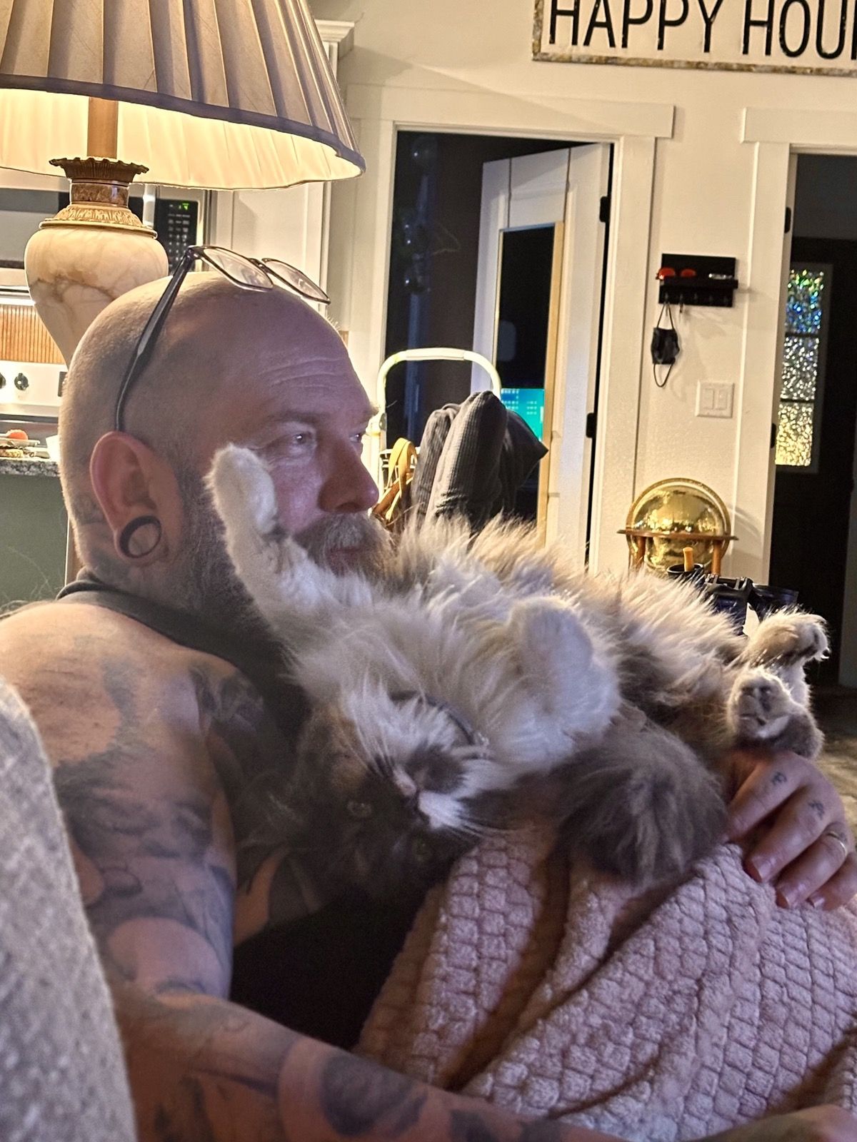 Mike holding Polly belly-up in his arms like a baby