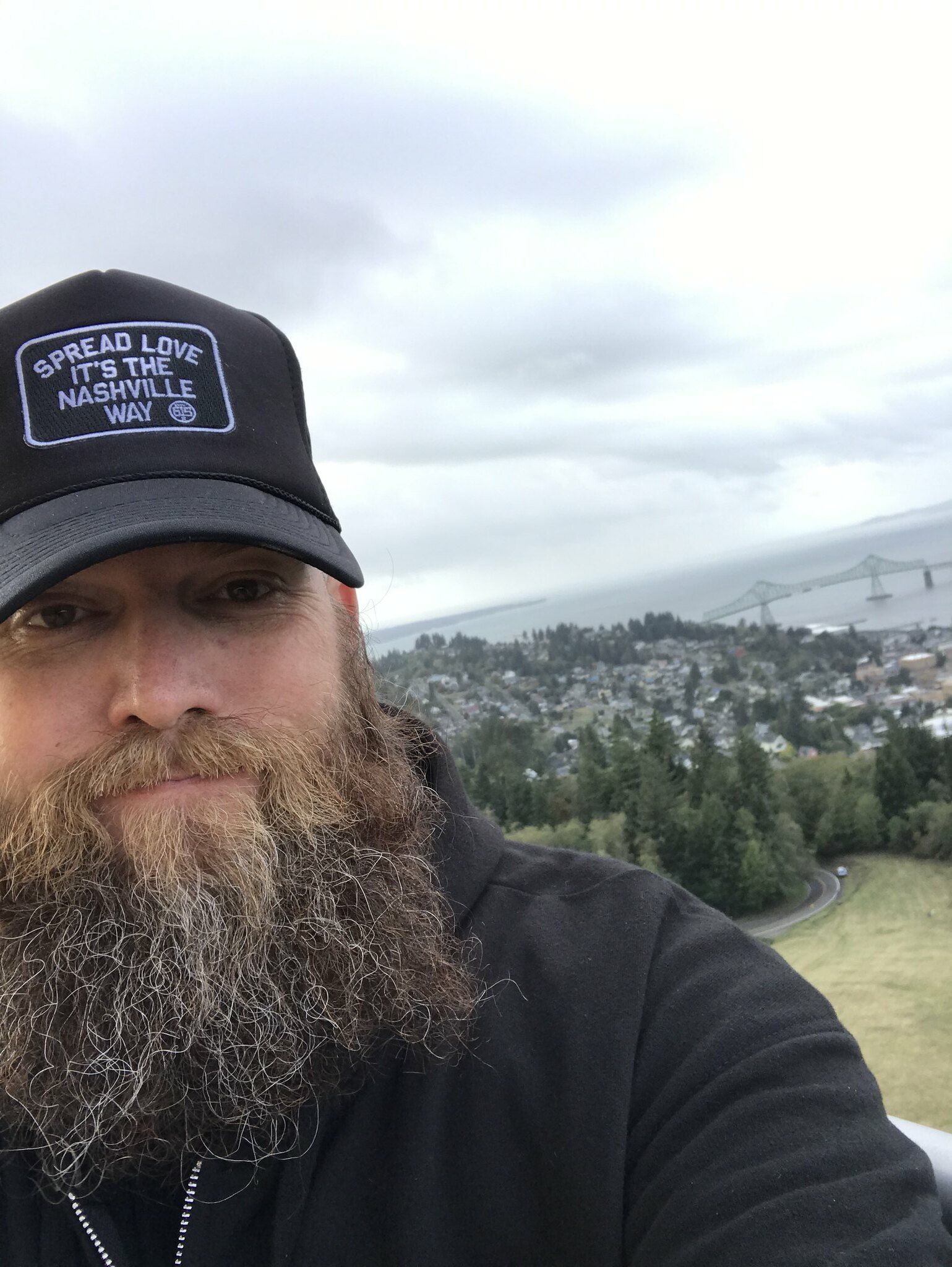 Selfie of Mike from the top of Astoria Column with the bay in the back ground.