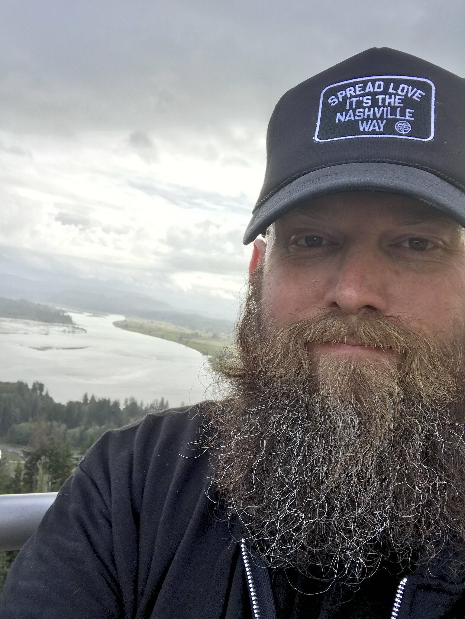 Selfie of Mike from the top of Astoria Column with the bay in the back ground.