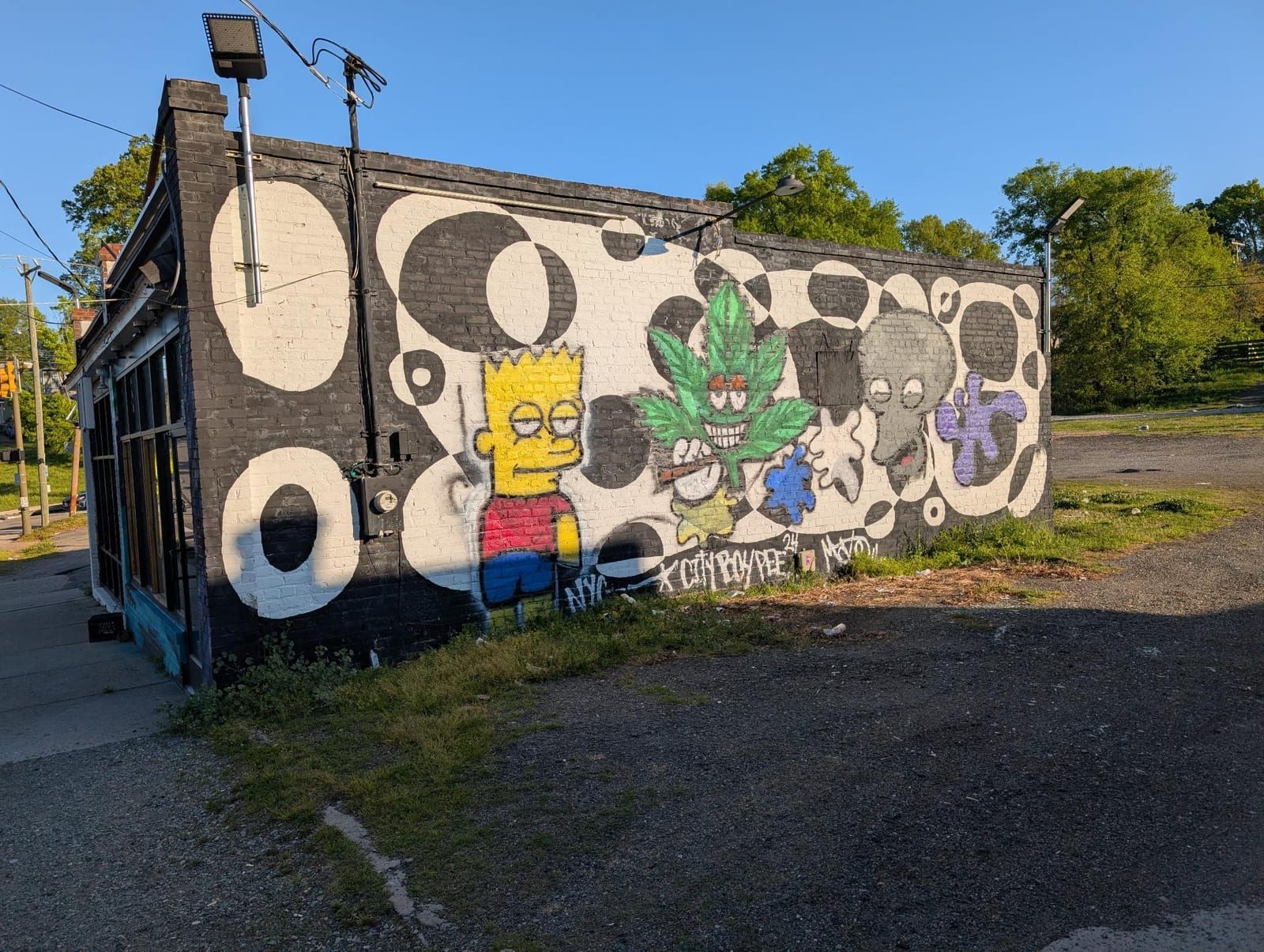 A mural on a building of Bart Simpson, a persona weed leaf and an octopus.
