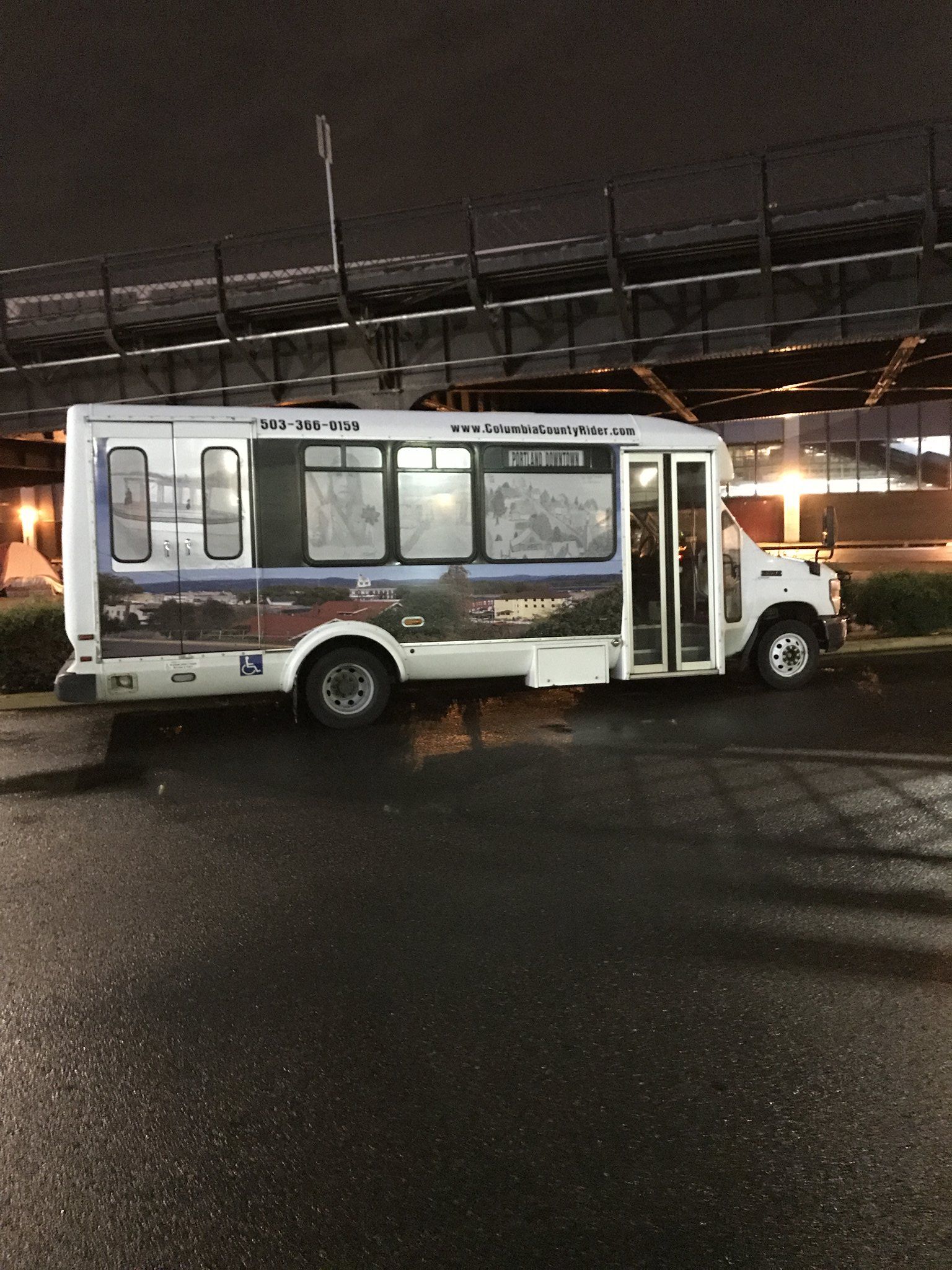 A shuttle bus in the predawn morning.