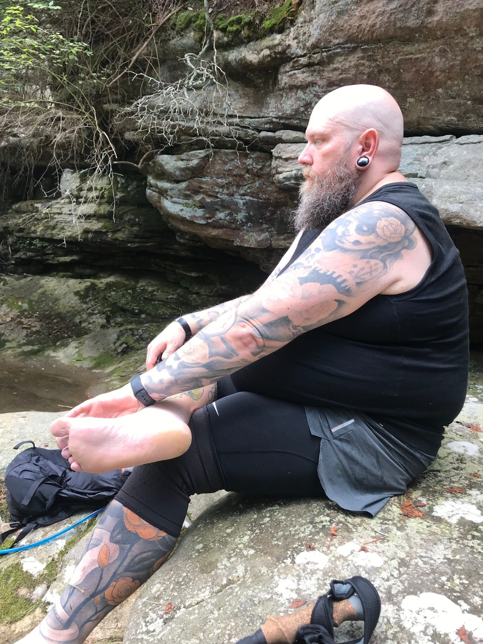 Mike sitting during our lunch break, shoes off and looking deep in throught.