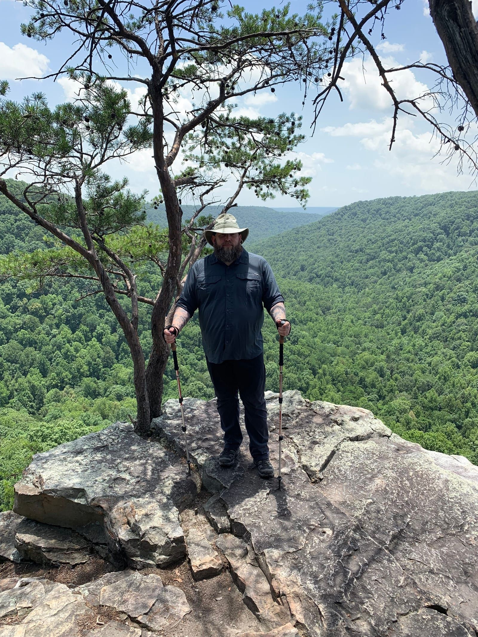 Photo of Mike on a bluff, wearing a dark shirt and pants.