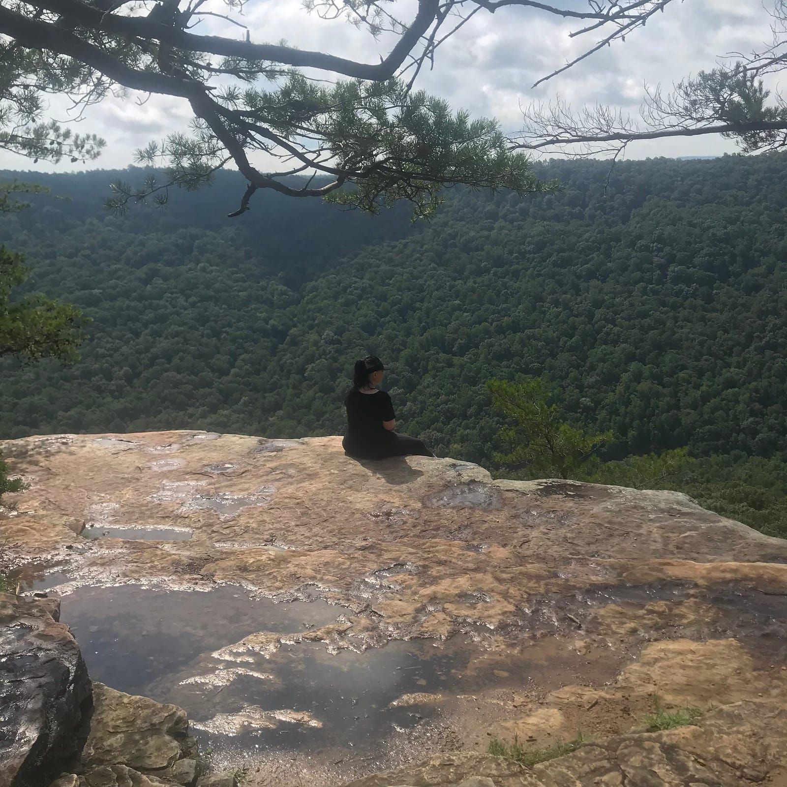 Meredith sitting on the edge of a bluff.