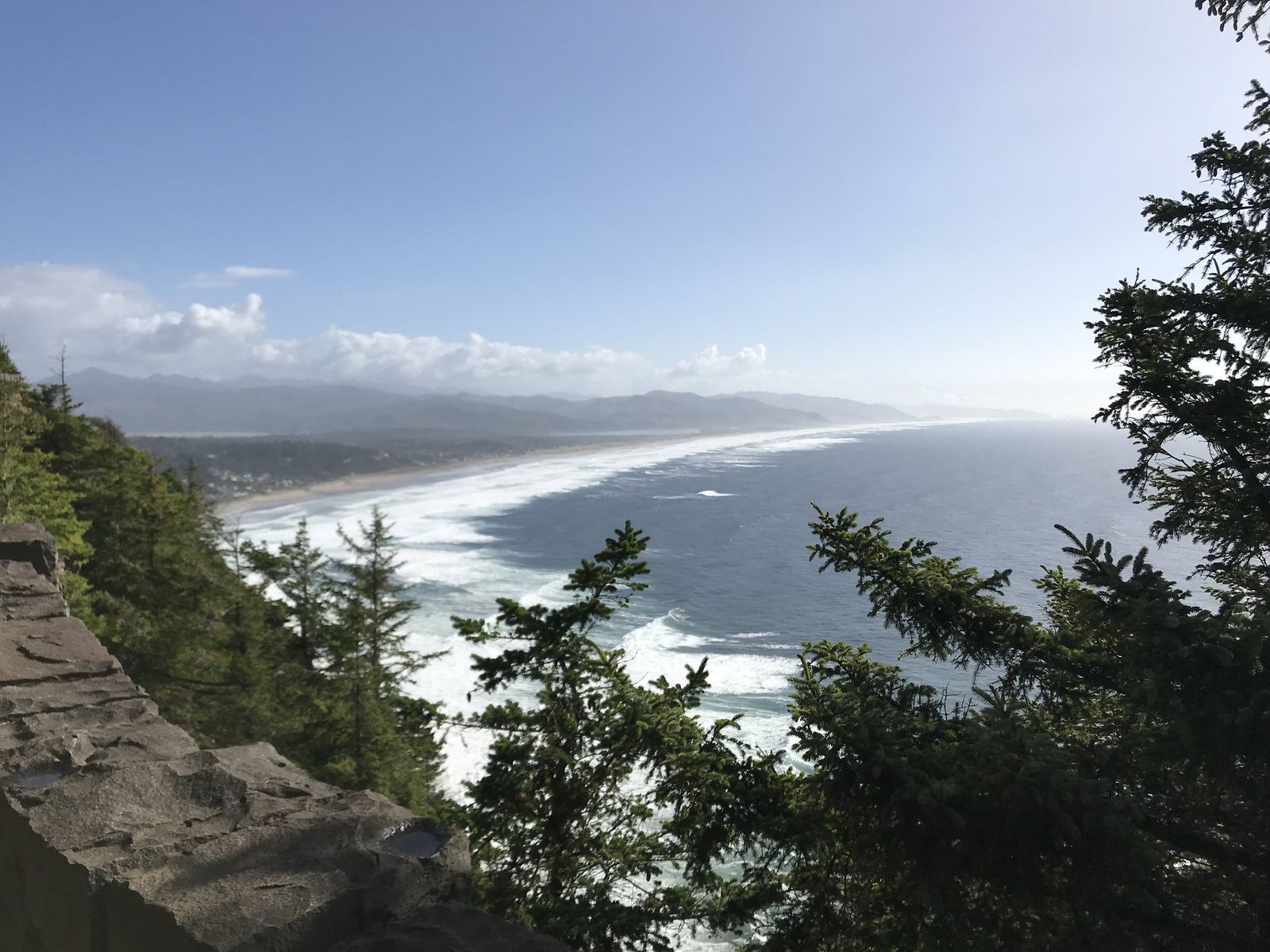 Photo from a cliff with the picturesque beach view in the distance.
