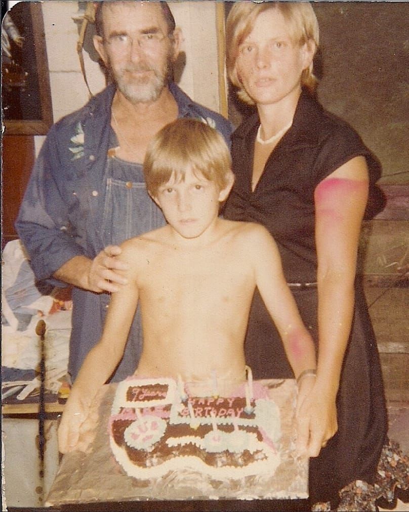 Dee, Linda and Michael pose for a photo, holding Michael's birthday caek for his 9th birthday.