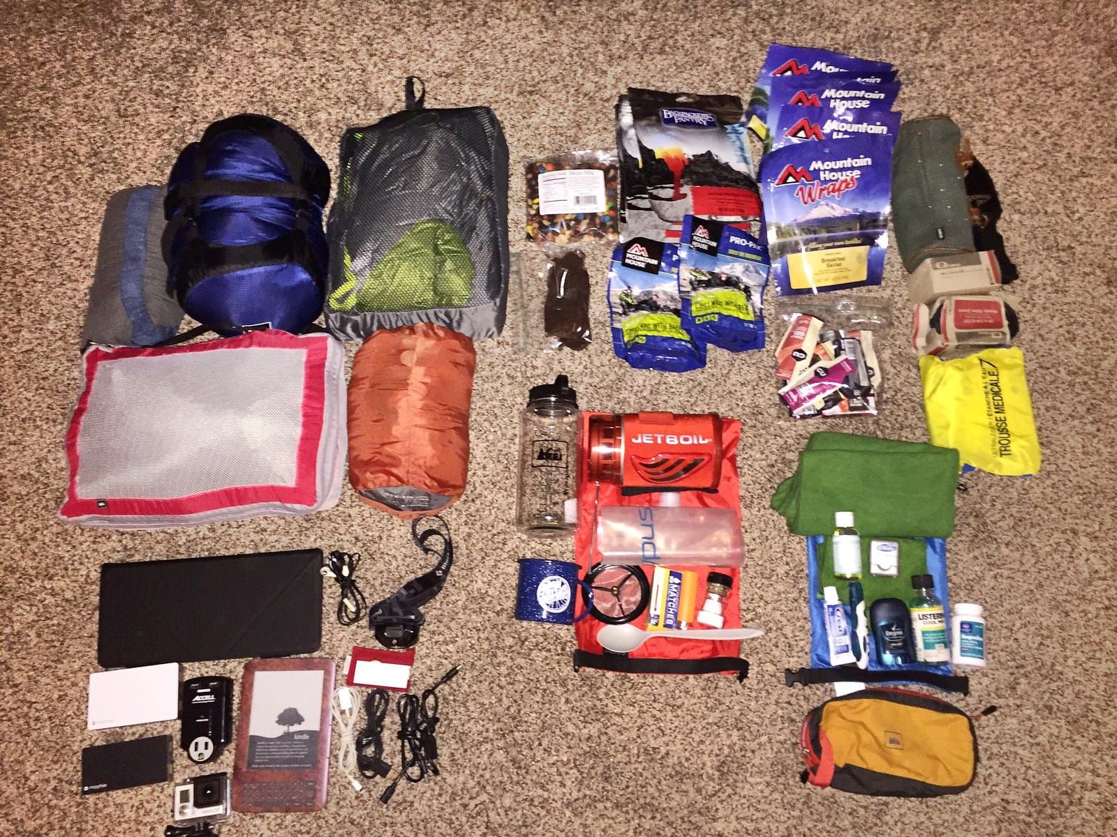 Photo of camping gear laid out on the floor.