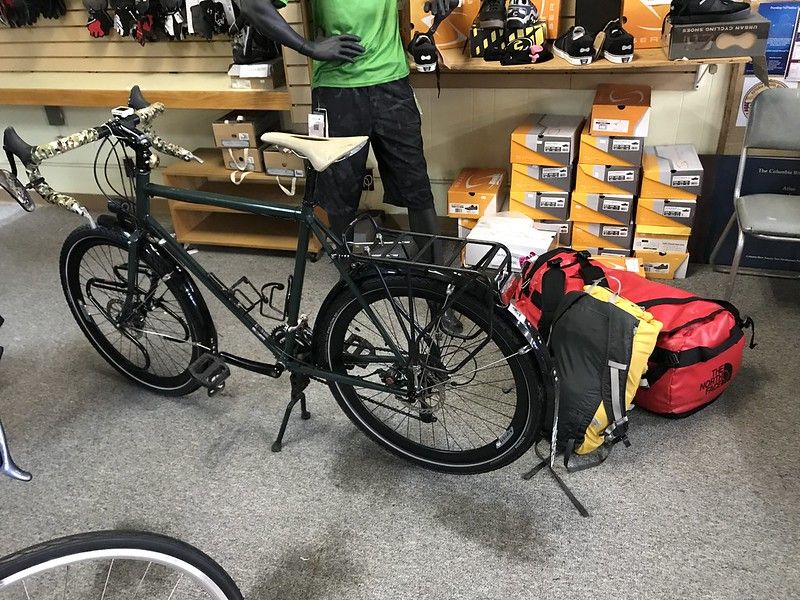 Clean and unloaded Surly Disc Trucker bicycle sitting at the bike shop.