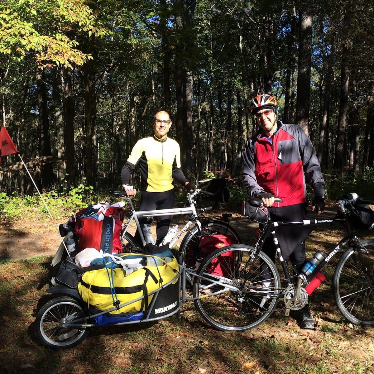 Bob and Pat standing with their loaded touring bicycles.