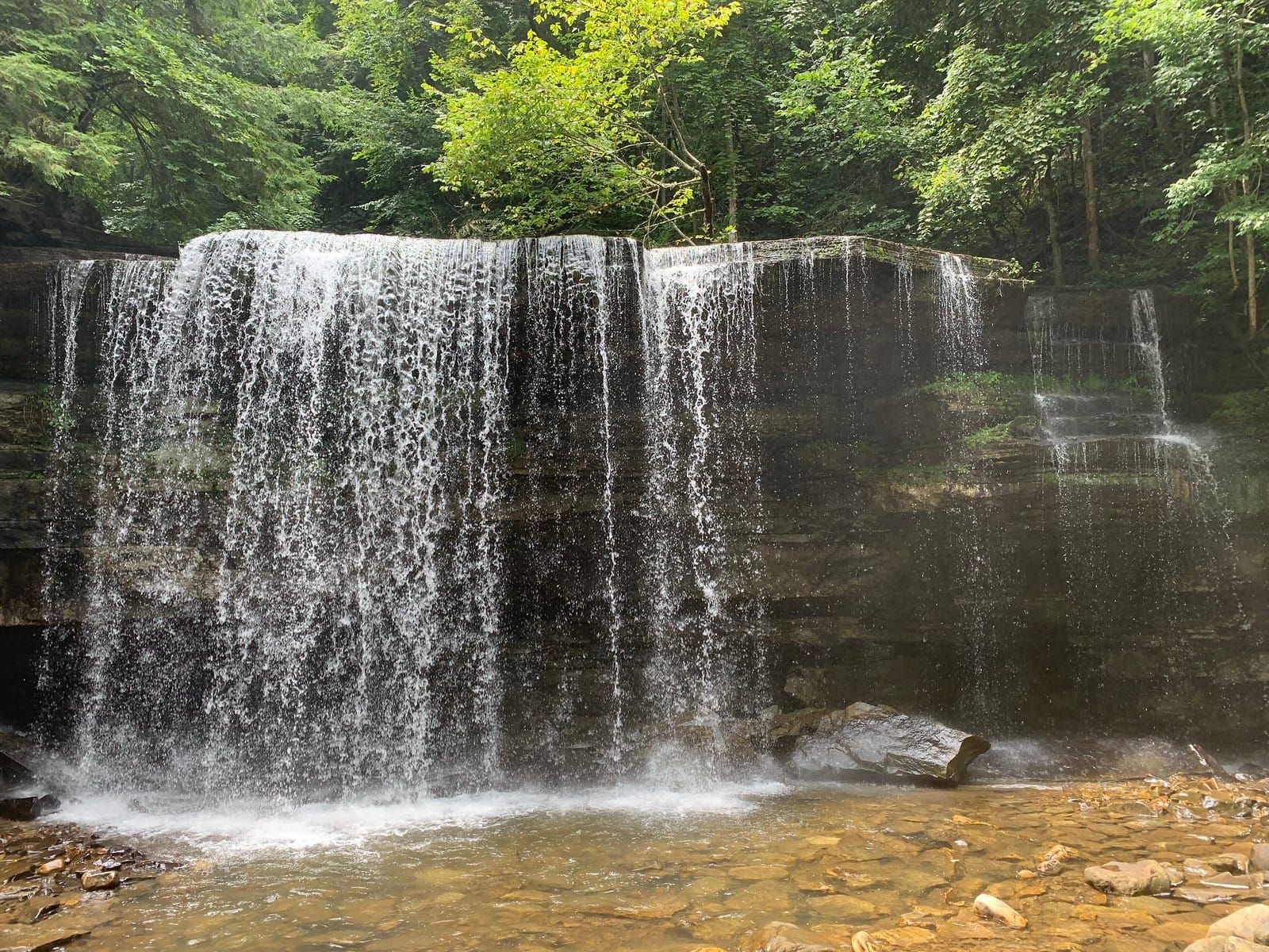 A water fall in the bright sunlight.