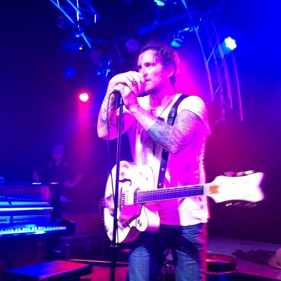 Butch Walker performing on stage.