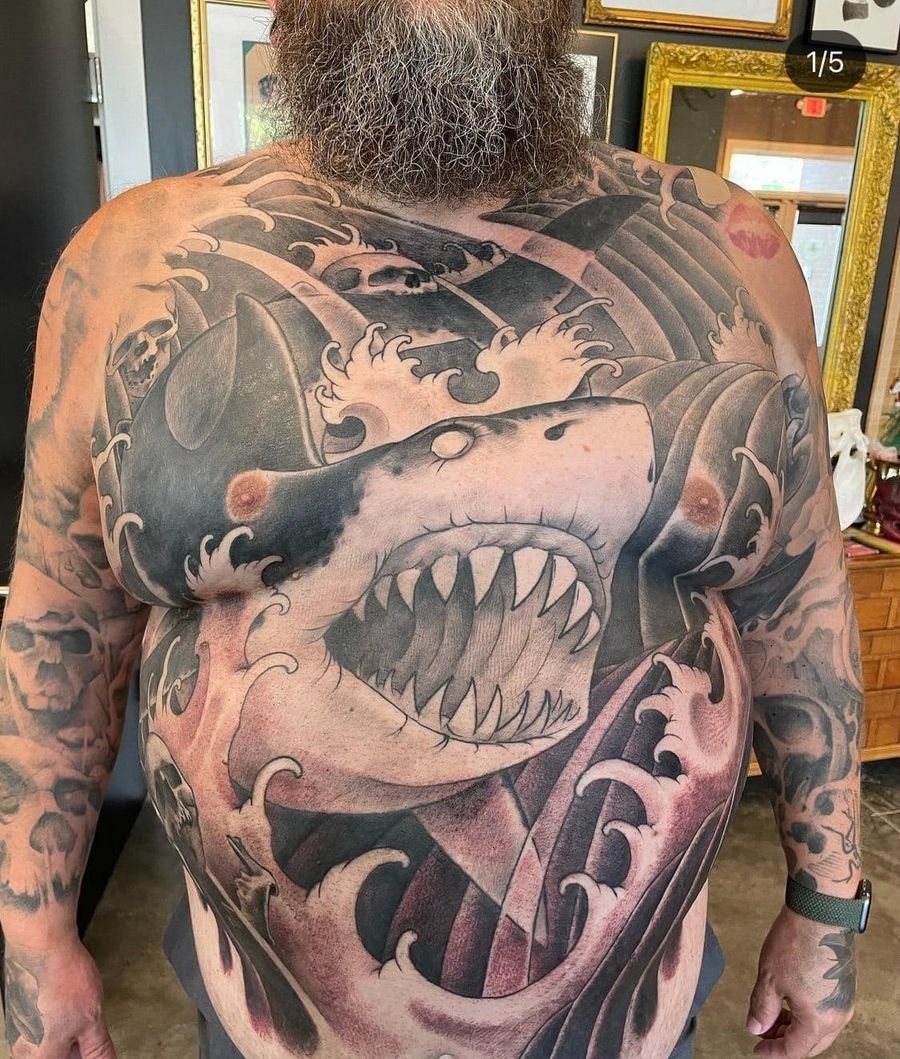 A full black and gray shark tattoo on Mikes torso.