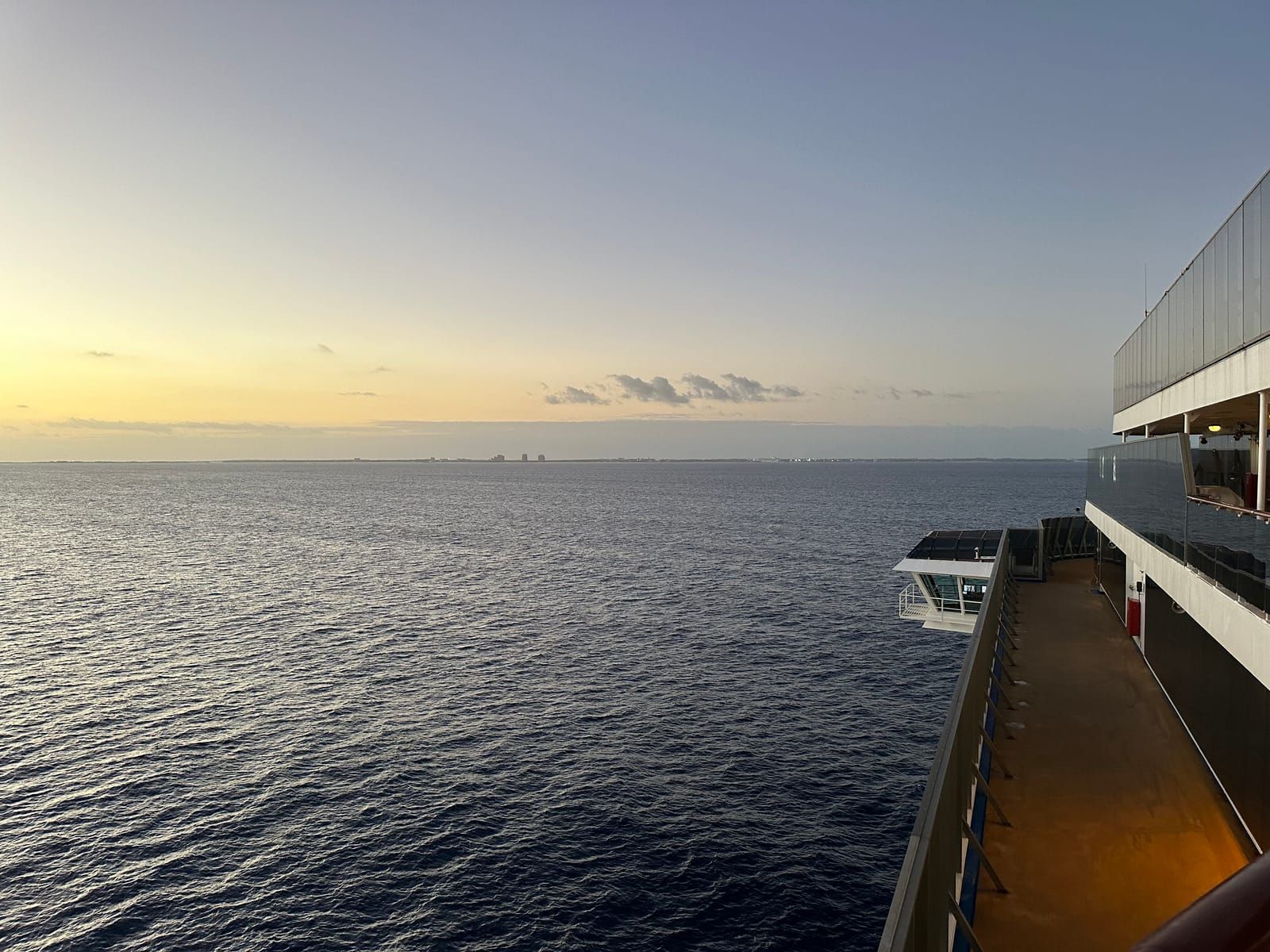 The island of Nassau in the medium distance from the side of the cruise ship.