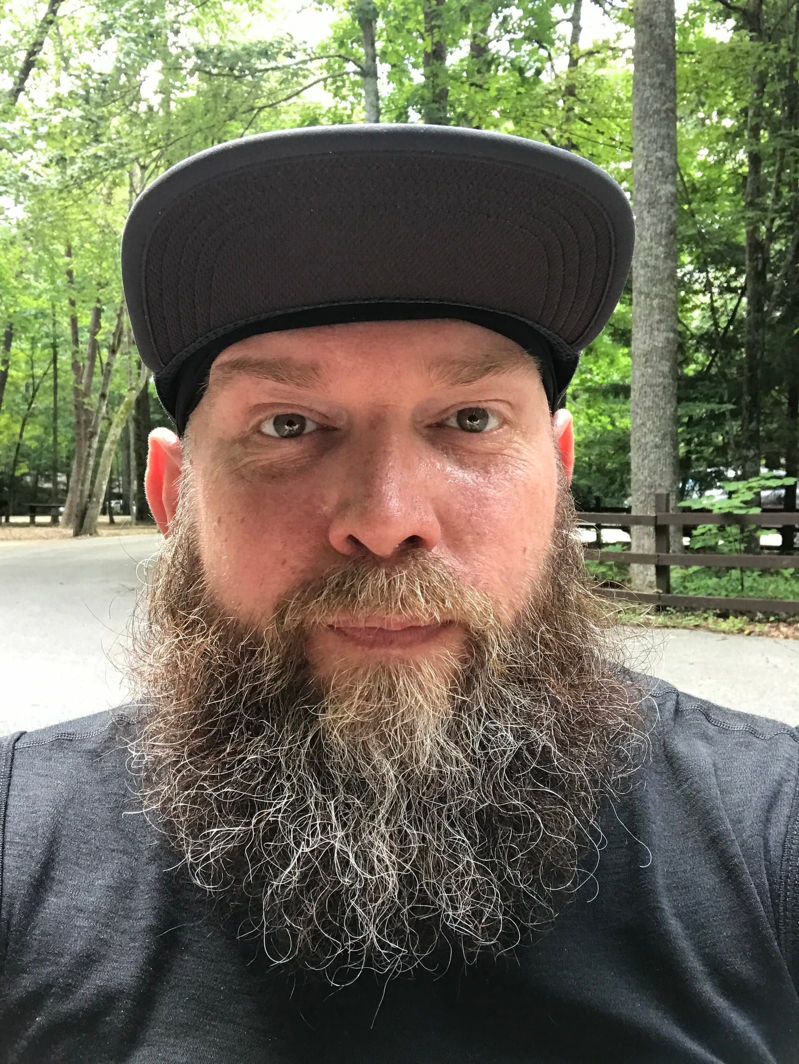 Selfie of Mike looking into the camera wearing a blue running hat.
