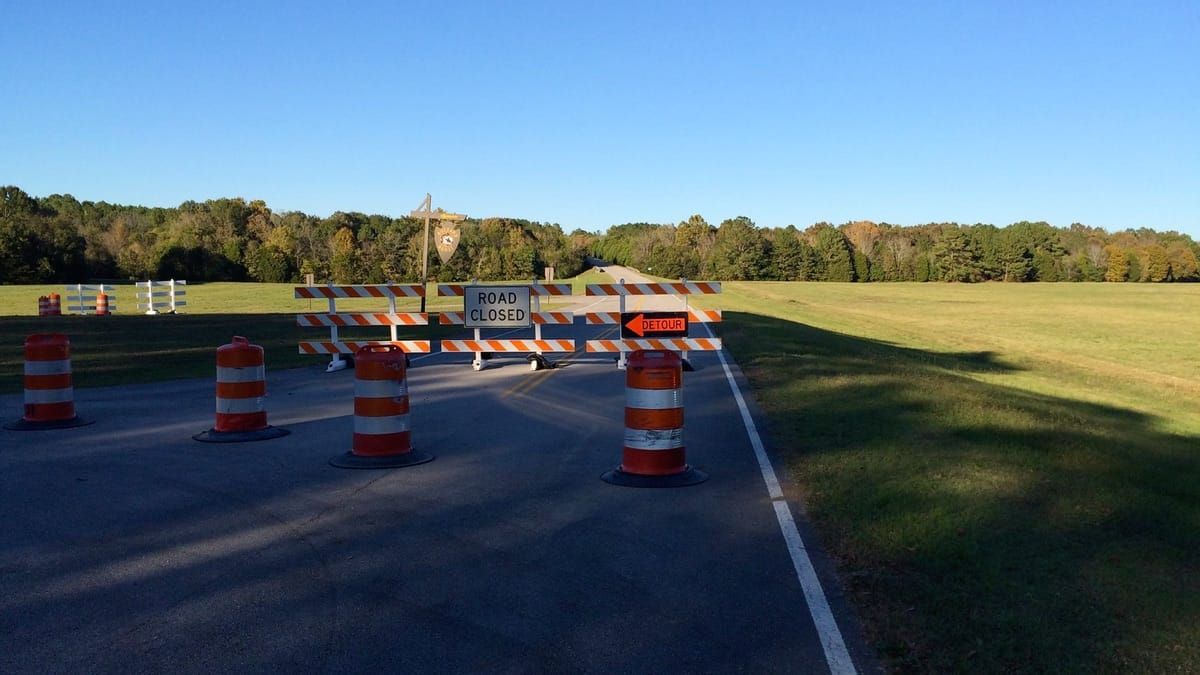 Road closed and detour signs.