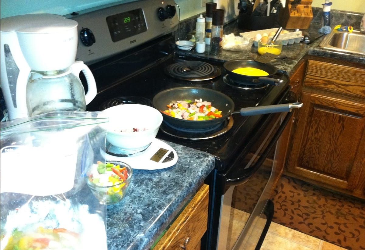 Omeletes being prepared on the stove.