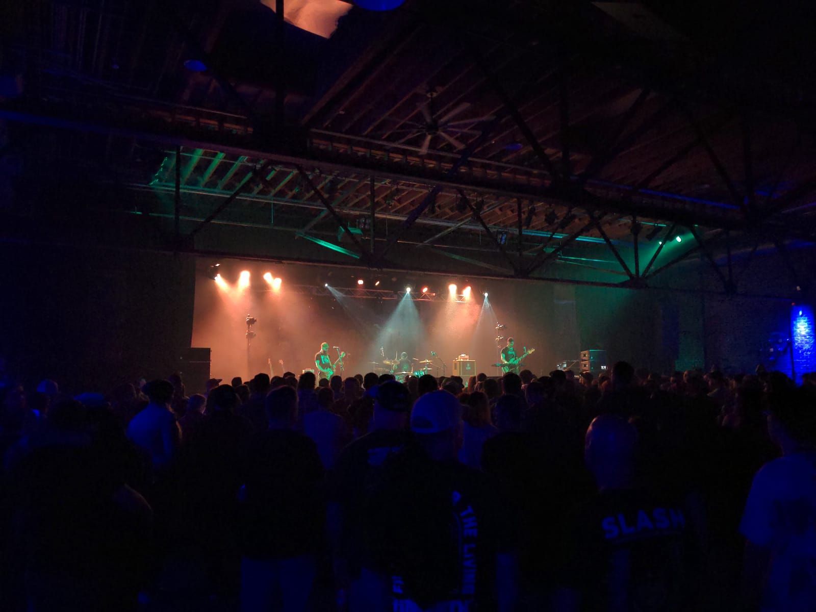 A band on stage in a dark venue.