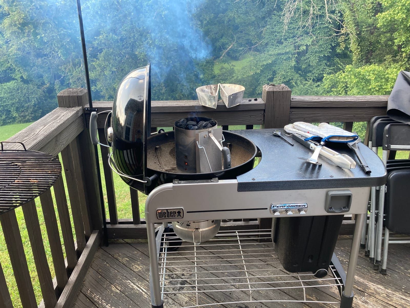 Freshly lit coals in the chimney starter on the weber grill.