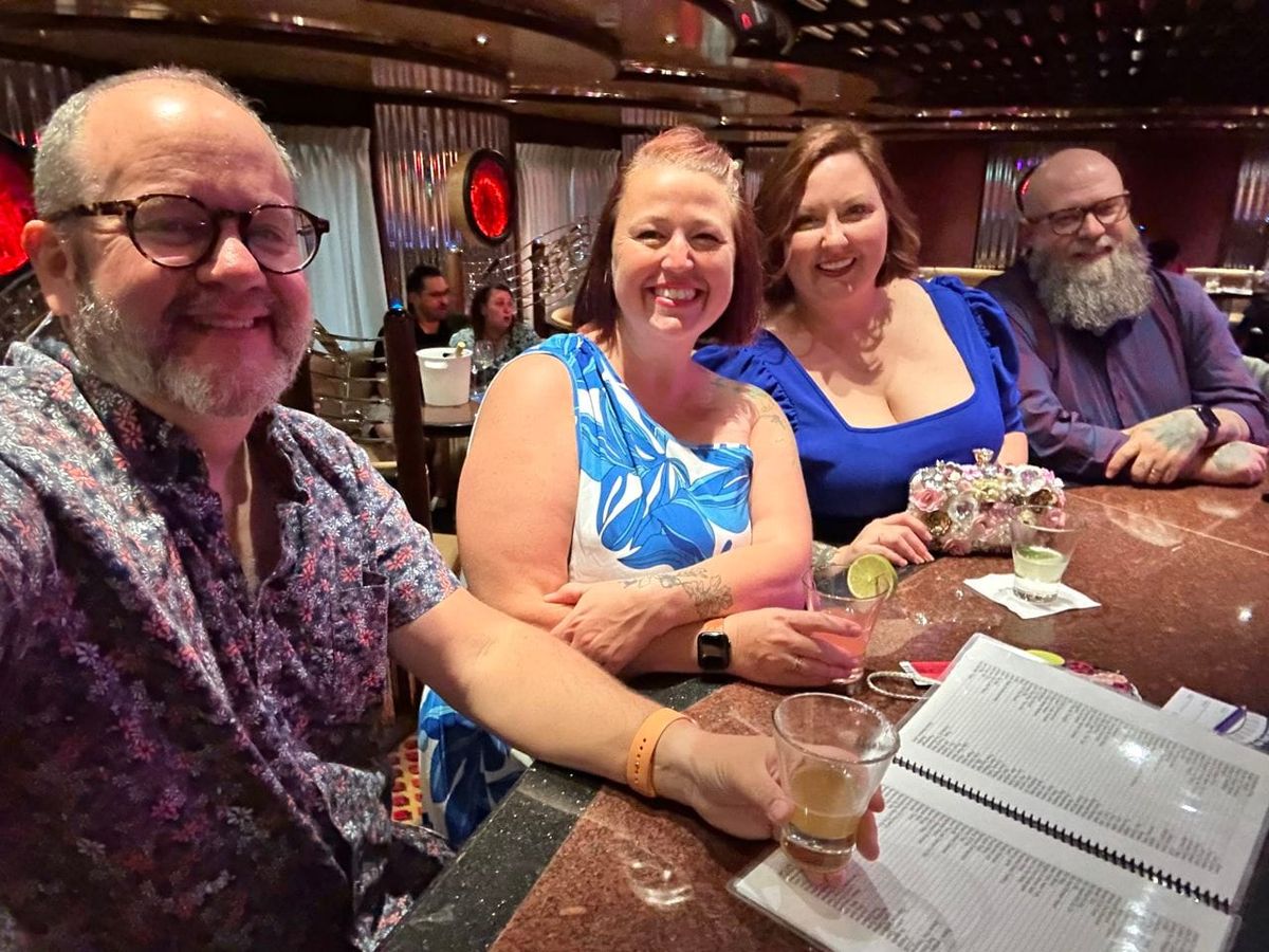 Selfie of Kevin, Tessica, Rachelle and Michael, having drinks at a bar, dressed up for dinner.