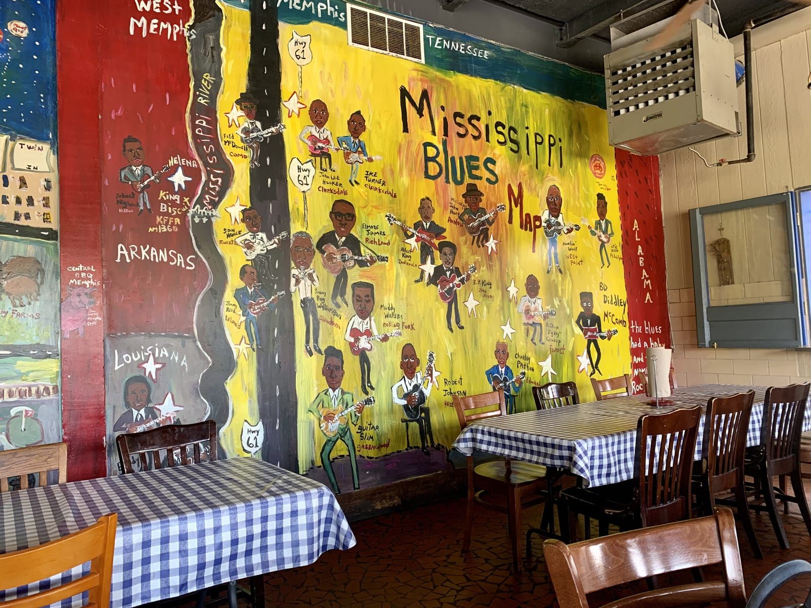 A mostly yellow mural depicting the Memphis Blues Map with many famous African American musicians.