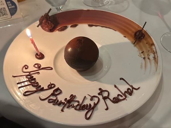 Decrative birthday dessert plate that has Rachelle's name spelled as Rachel.