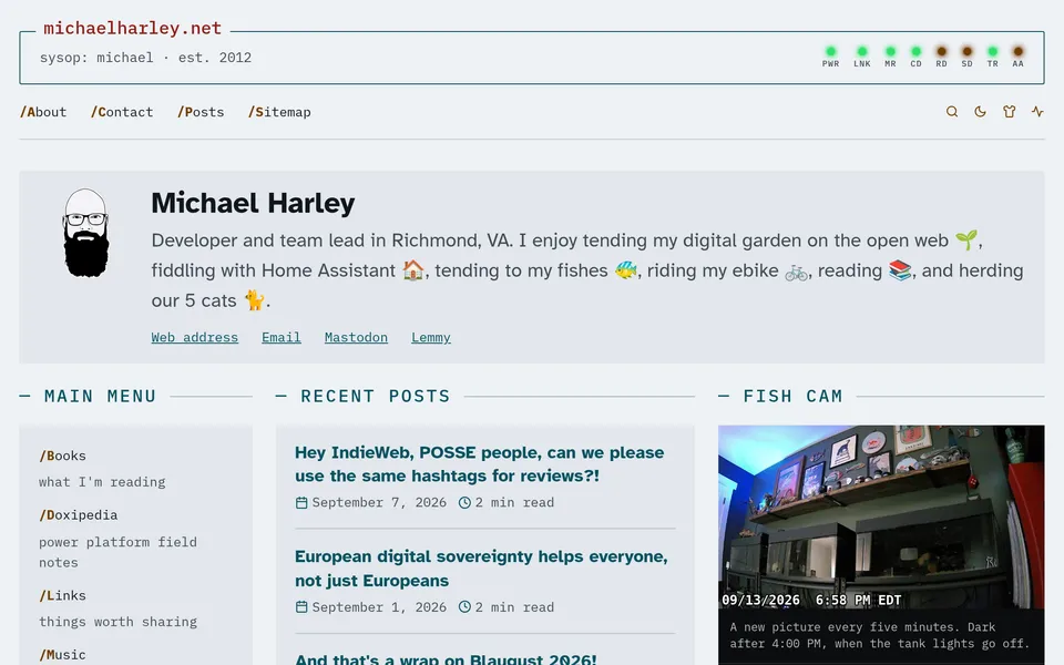 The homepage in the BBS skin: a framed console header with modem lights, the intro card, and three columns for the main menu, recent posts and the fish cam.