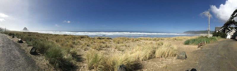 Panorama photo of a sunny Cannon beach.