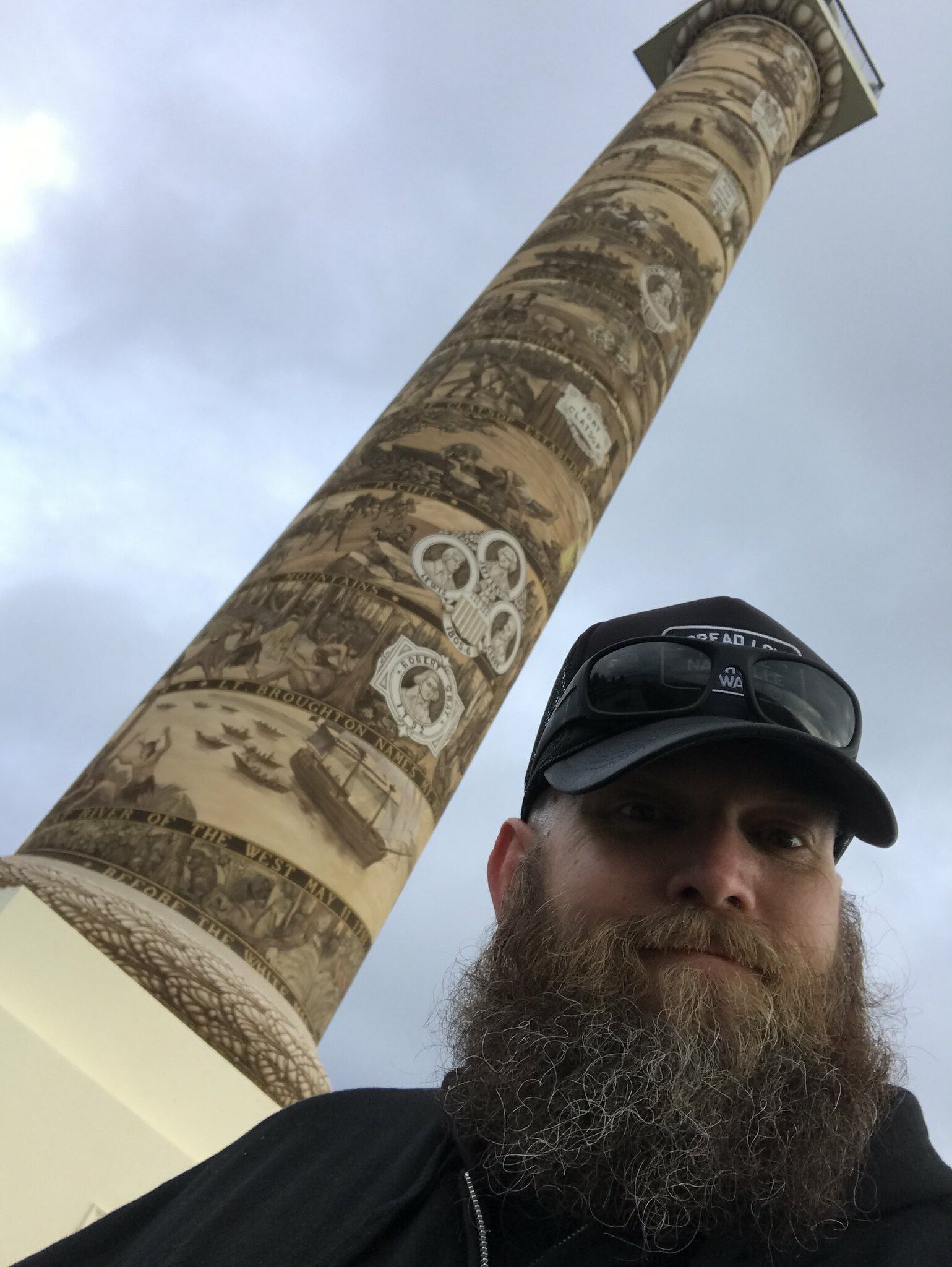 Selfie of Mike from the bottom of Astoria Column with the column in the back ground.