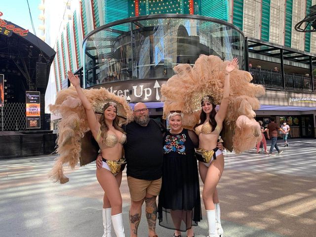 Mike and Rachelle posing with carnival girls for a photo.