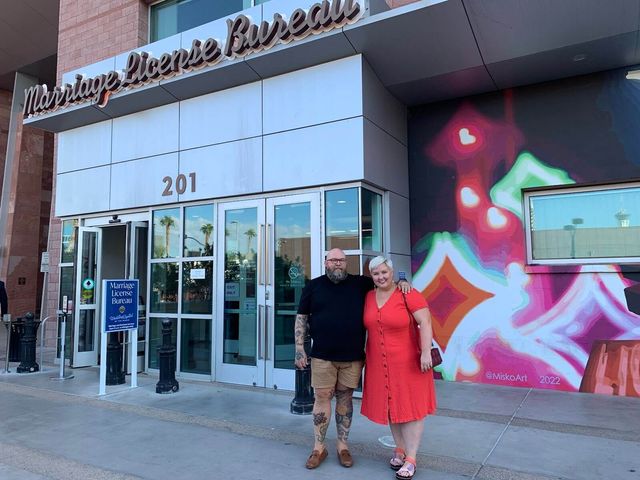 Mike and Rachelle posing in front of the Las Vegas marriage license office.