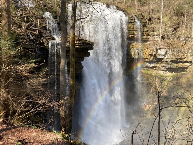 A full Virgin Falls with a rainbow showing in the mist of the falls.