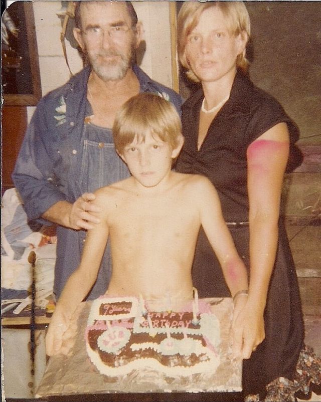 Dee, Linda and Michael pose for a photo, holding Michael's birthday caek for his 9th birthday.