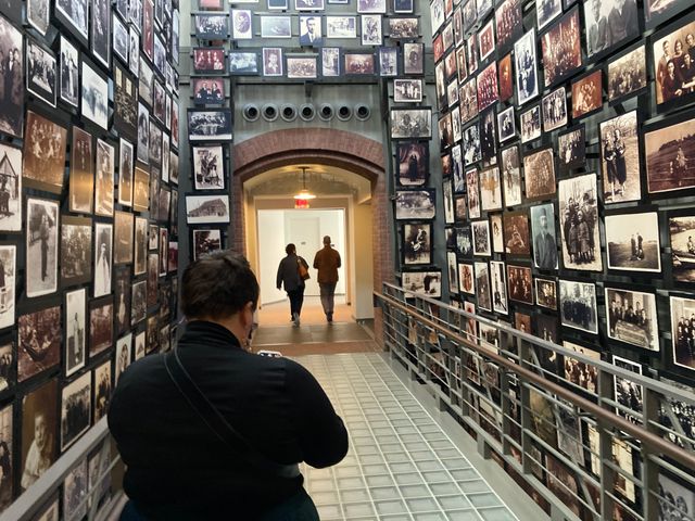 Rachelle viewing the walls of photos of Jewish people who were killed in the Holocaust.