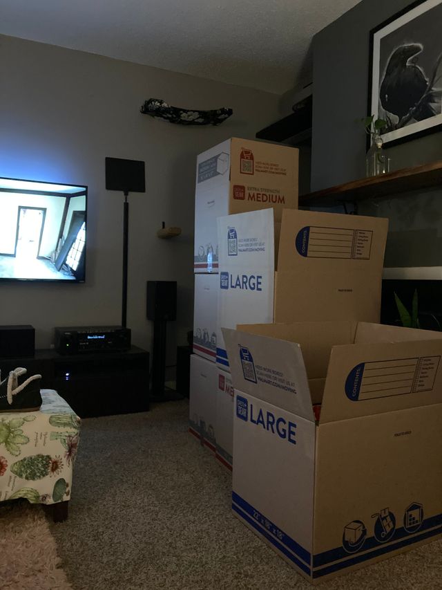Empty moving boxes in the living room in preparation for our move to the new house.