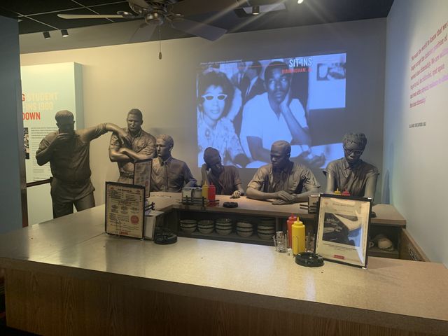 Museum statue display of the 50s civil rights diner sit ins of Birmingham. African Americans sit at the counter wile white men stand nearby trying to intimidate.
